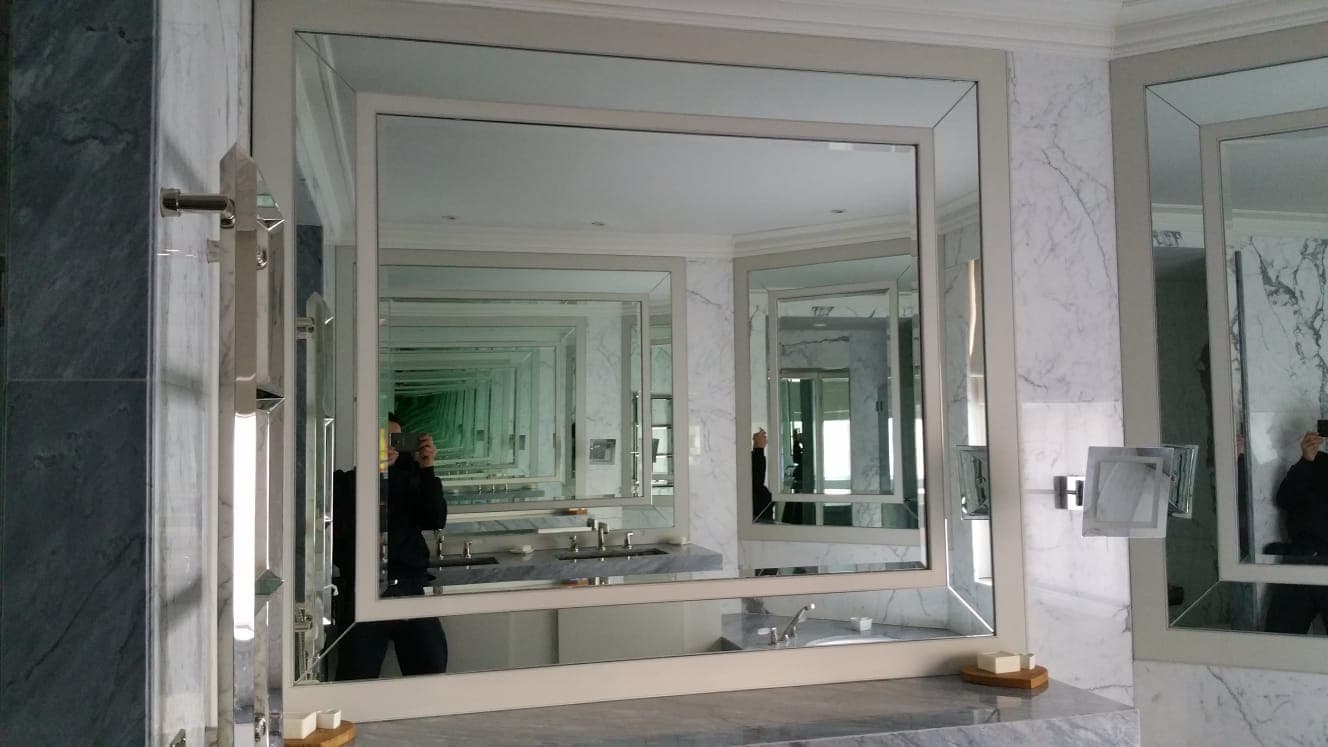 Bevelled framed mirror panel above a stone vanity