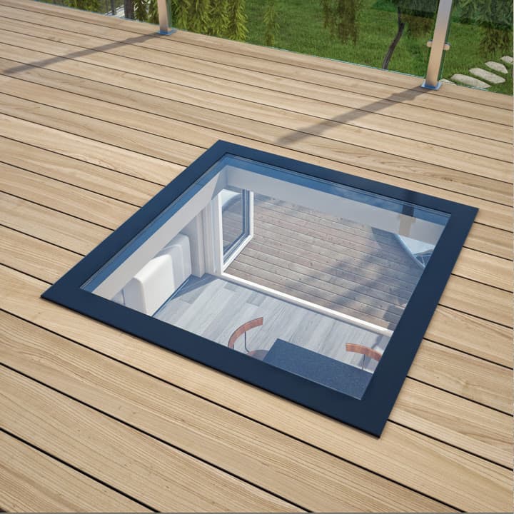 A square walk-on rooflight set into decking, looking down into the room below